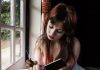 Some Day I Will be Someone’s Ancestor Sad woman writing in her jounal by the window could be someone's ancestor one day