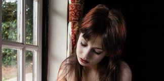 Some Day I Will be Someone’s Ancestor Sad woman writing in her jounal by the window could be someone's ancestor one day